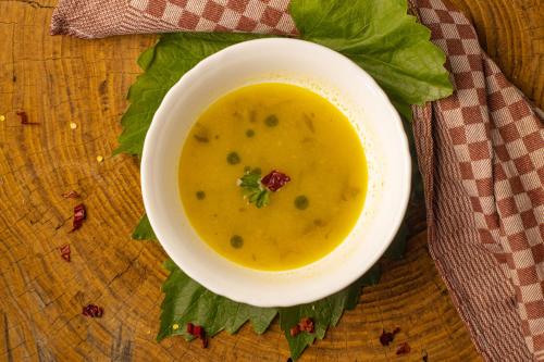a bowl of soup on a table with a napkin at Villa Dihovo in Bitola