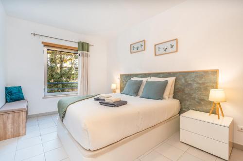 a bedroom with a large bed and a window at Sea Breeze in Portimão