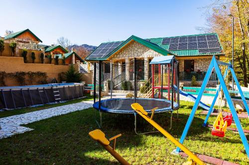 a playground with a swing set in a yard at Elite Rooms Kolasin in Kolašin