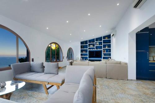 a living room with a couch and a table at Maripins Villa con jacuzzi y vistas únicas al mar in Banyalbufar
