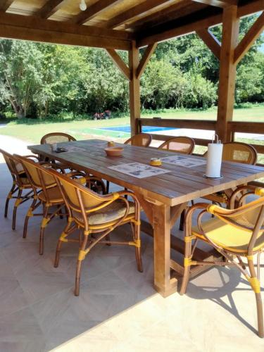 a wooden table and chairs on a patio at Vikendica Čardak in Srebrenik
