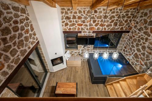 an overhead view of a kitchen with a stone wall at Πηγή Τραγανιστή in Kato Trikala Korinthias