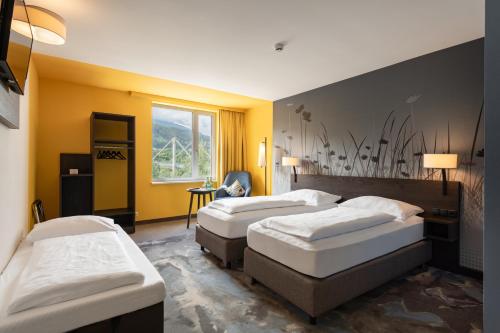 Postel nebo postele na pokoji v ubytování Hwest Hotel