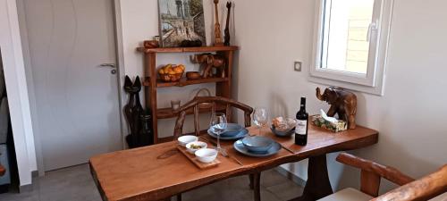 ein Holztisch mit einer Flasche Wein darauf in der Unterkunft Villa proche plage pour 2 pers in Vielle-Saint-Girons