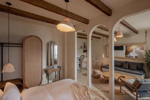 a bedroom with a bed and a living room at Serab Residencia, Boutique Hotel & Resort in Al Kaslīk