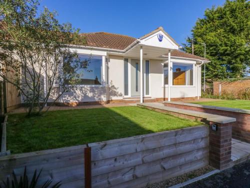 a house with a retaining wall and a yard at Farmer's Rest in Ely