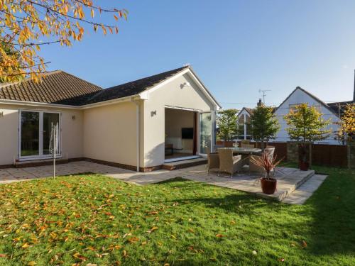 a home with a patio and a yard at Farmer's Rest in Ely