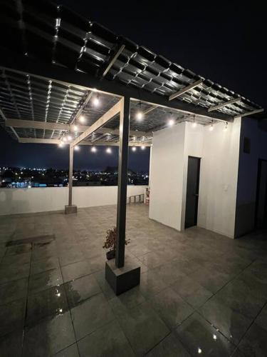 a large room with lights on a building at night at Departamento en Ibarra, Cerca a todo in Ibarra