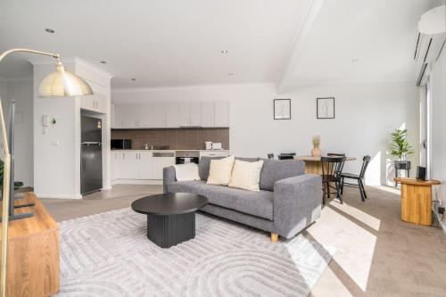 a living room with a couch and a table at 3BR Modern Apt Prime Location 7 Mins to CBD - Hosted by Canstay in Canberra