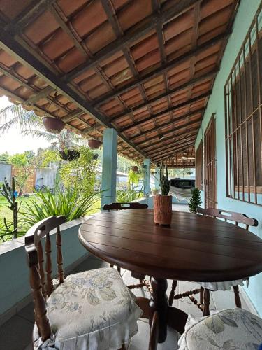 a wooden table and two chairs on a porch at Apartamento Santa Cruz in Santa Cruz