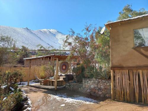 a house with a table and a fence in a yard at Canto Del Viento, Horcon 4 personas in Horcon