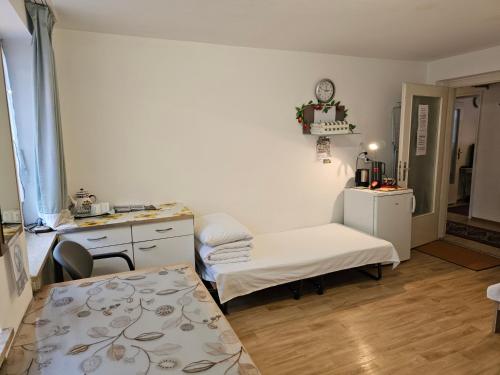 a hospital room with a bed and a table at China-Ferienzimmer in Berchtesgaden