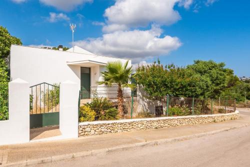 a white house on the side of a road at Villa Elena Dorada in Port d'Addaia