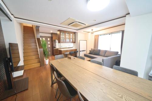 a living room with a table and a couch at FINOA Residential Suite Kamata in Tokyo