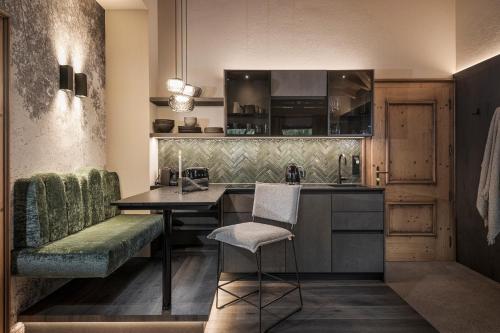 a kitchen with a table and a chair in a room at Villa Haidacher Relax & Lifestyle Apartments in Zell am Ziller