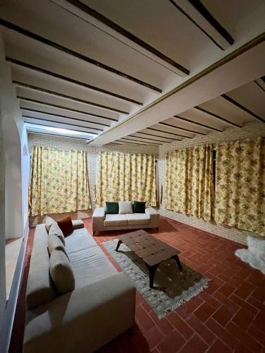 a living room with a couch and a table at Dar Ali - Guesthouse in Tozeur