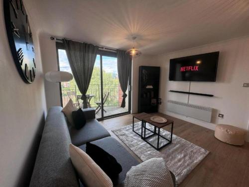 a living room with a couch and a tv at Birmingham City Centre 2-Bed with Private Balcony in Birmingham