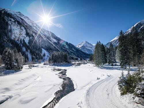 a river in the snow with mountains in the background at Apartment Edith in Telfes im Stubai