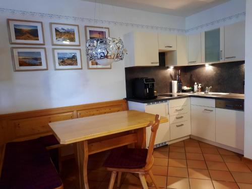 a kitchen with a wooden table and chairs in it at Ferienhaus Bad Waltersdorf im Biodorf in Bad Waltersdorf