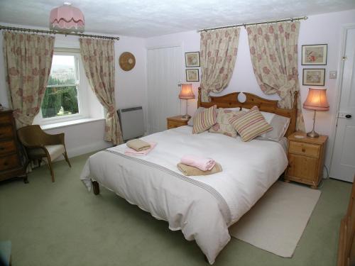 a bedroom with a bed with two hats on it at Corner House in Grinton