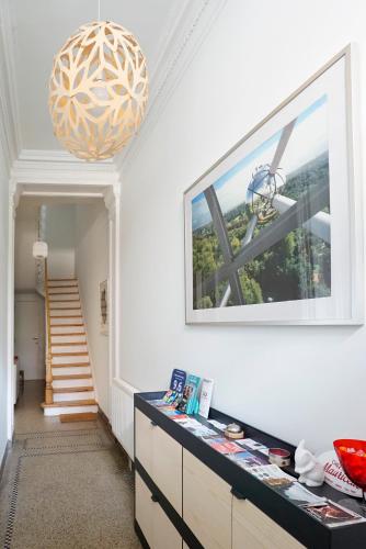 a hallway with a table and a large window at B&B Home & the City in Brussels