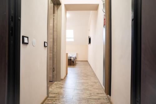 a hallway with white walls and a tile floor at RIVER SIDE in Polyana