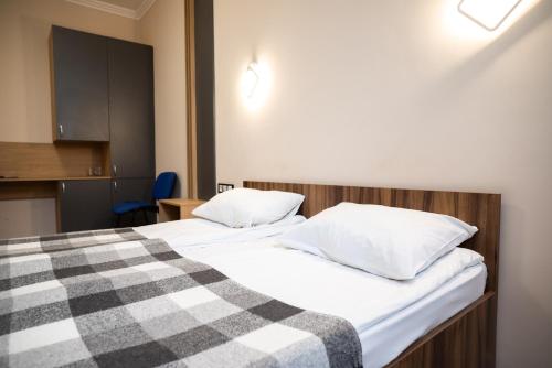 a bedroom with two beds with a checkered blanket at RIVER SIDE in Polyana
