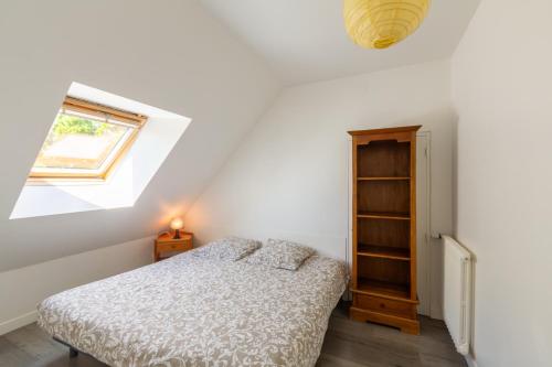 a bedroom with a bed and a window at Ty Pierre in Plérin