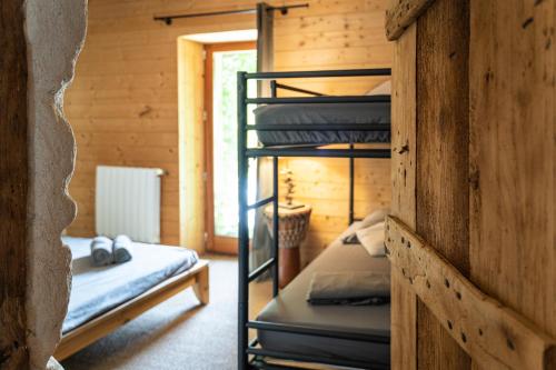 a room with two bunk beds in a cabin at La Grange de Capucine, gite de caractère in Chainaz-les-Frasses
