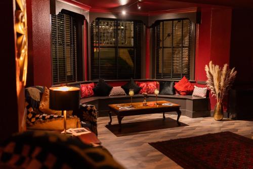 a living room with a couch and a table at The Lansdowne, Eastbourne in Eastbourne