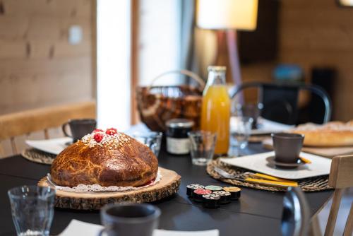 a table with a loaf of bread on top of it at La Grange de Capucine, gite de caractère in Chainaz-les-Frasses