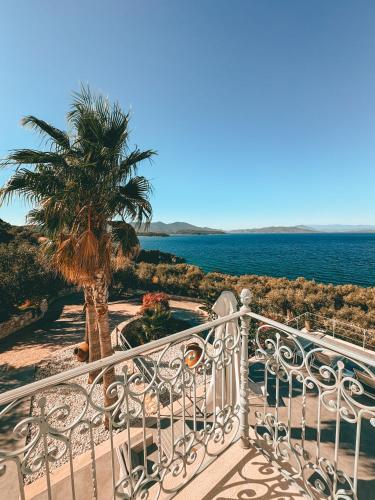 a balcony with a view of the ocean and a palm tree at Luxury Apartments La Villa in Chorto