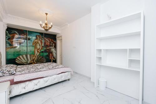 a bedroom with a bed and a painting on the wall at SkyHouse-High Comfort Gem in Central Downtown in Chişinău