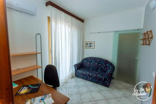 a living room with a chair and a table at Lo Zio Michele Apartments in Nuova Gibellina