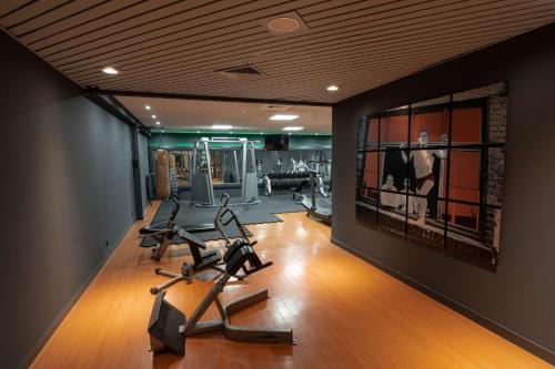 a gym with treadmills and exercise equipment in a room at Radisson Blu Hotel Dortmund in Dortmund