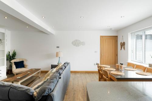 a living room with a couch and a table at Ranalegh Court in Saint Columb Minor