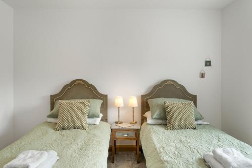 two beds sitting next to each other in a bedroom at Ranalegh Court in Saint Columb Minor