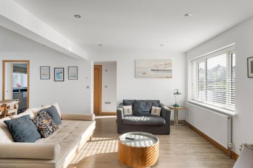 a living room with a couch and a table at Ranalegh Court in Saint Columb Minor