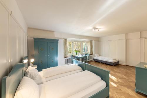 a living room with a couch and a table at Hotel Chesa Spuondas in St. Moritz