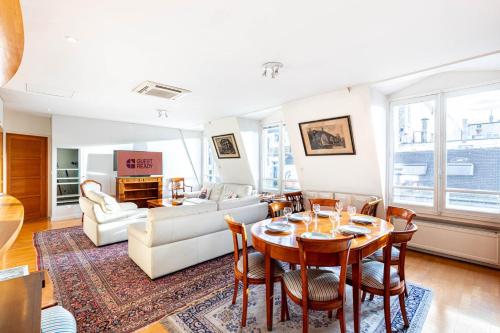 un salon avec une table et un canapé dans l'établissement GuestReady - Spacious Comfort in the 8th, à Paris