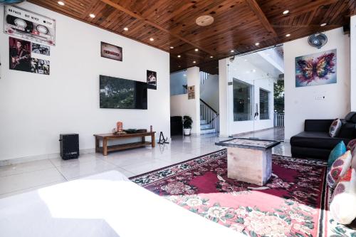 a living room with a couch and a table at The Bunksters Mcleodganj, Dharmkot in McLeod Ganj