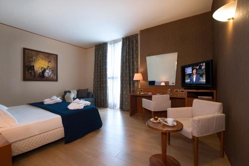 Postel nebo postele na pokoji v ubytování Hotel Parma & Congressi