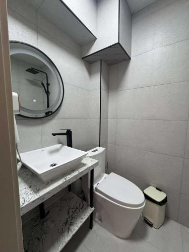 a bathroom with a sink and a toilet and a mirror at Erkhes hotel in Dalandzadgad