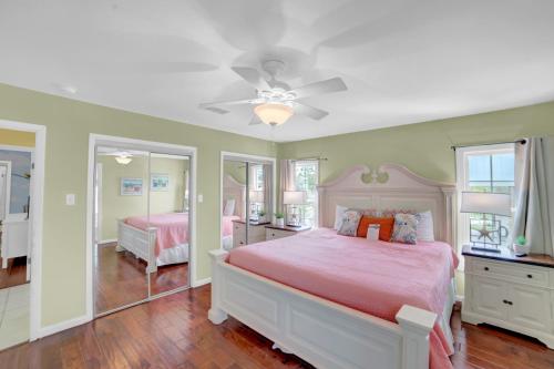 a bedroom with two beds and a ceiling fan at Fun In The Sun by Vacation Homes Collection in Orange Beach