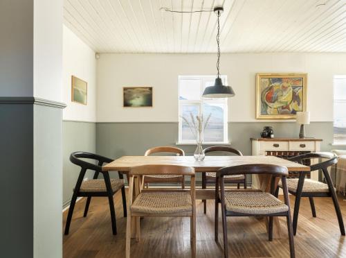 a dining room with a table and chairs at Hvammsvík Nature Resort in Kjósahreppur