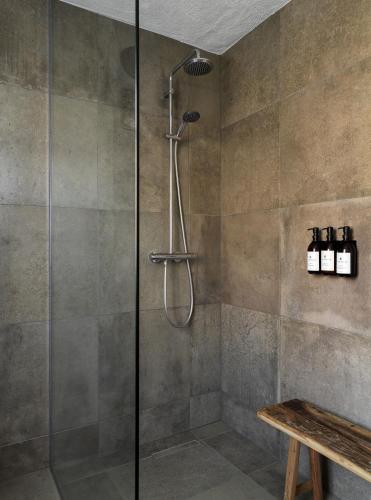 a shower with a glass door in a bathroom at Hvammsvík Nature Resort in Kjósahreppur