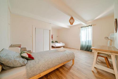 a room with a bed and a desk in it at Appartement - Grande terrasse in Marsanne