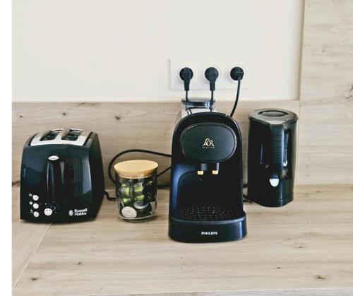 a black blender sitting on a counter next to a toaster at Appartement - Grande terrasse in Marsanne
