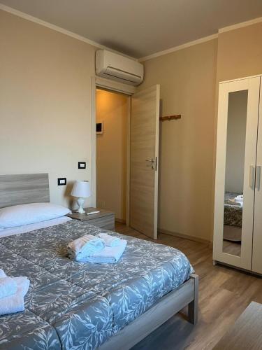 a bedroom with a bed and a door to another room at Appartamenti la Piazzetta vicino a Firenze in Signa