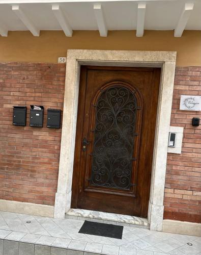 a wooden door on a brick building with a brick wall at Il terrazzino in Ceprano